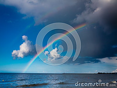 Landscape view on sky with rainbow at sea. Stock Photo