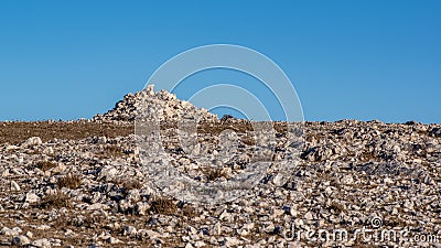 Landscape view of stacked stones on top of highest point Obzova of Island Krk. Stock Photo