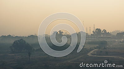 A landscape view of a Village, countryside covered in a layer of mist and fog Stock Photo