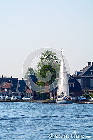 Landscape with waterways and canals of North Holland with boats, canal-side lifestyle in the Netherlands Stock Photo