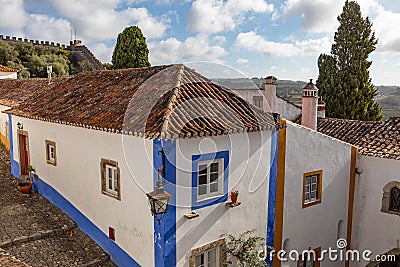 Landscape with white stucco buildings and terracotta roof tops, chimneys and cypress tree with countryside Stock Photo