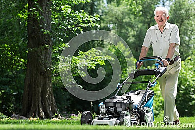 Landscape worker mowing grass Stock Photo