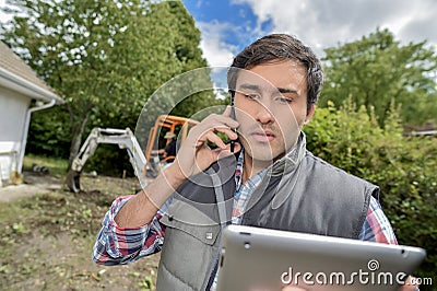 Landscaper on the phone Stock Photo