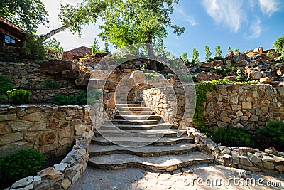 Landscaping. Decorative stone steps down the hill Stock Photo