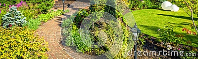 Landscaping in nice green garden in summer. Panoramic view of landscaped place at residential house Stock Photo