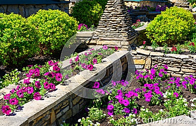 Landscaping with retaining walls and flowerbeds in residential house backyard Stock Photo