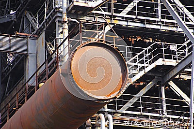 Landschaftspark Duisburg, Germany: Corroded rusty tube protrude from steel tower with staircases Stock Photo