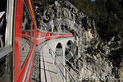 The RhÃ¤tische railway on its way through the swiss alps Editorial Stock Photo