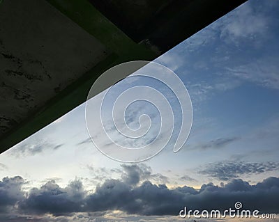 the evening sky with the expanse of clouds partially covered by the roof Stock Photo
