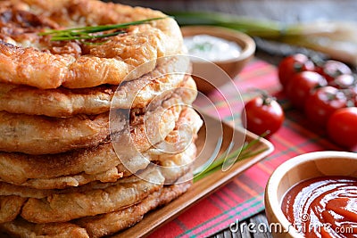 Langos with ketchup and cheese. Stock Photo