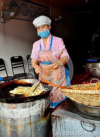 Langzhong, China: Woman Frying Noodles Editorial Stock Photo