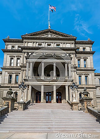 Lansing MI - May 6, 2023: Main entrance to the Michigan Capitol building with ornate marble, steps and lamppost Stock Photo