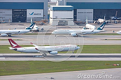 Cathay dragon`s passenger airplane is landing in runway, Cathay Pacific`s Passenger Editorial Stock Photo