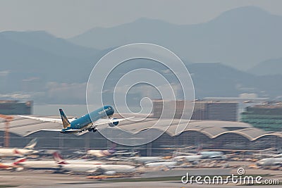Vietnam Airlines airplane is running for take off at runway, all parking space is fully Editorial Stock Photo