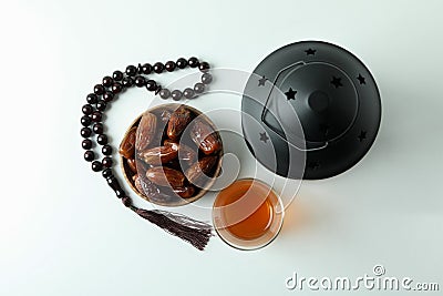 Lantern, rosary, glass of tea and bowl of dates on white background Stock Photo