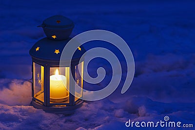 Lantern on snow Stock Photo
