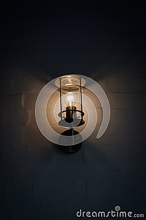 Lantern at wall illuminating darkness Stock Photo