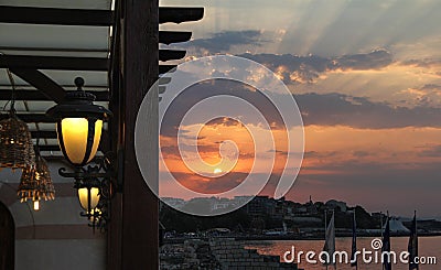 Lantern on a wooden pole in an outdoor cafe. Stock Photo