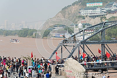 LANZHOU, CHINA - OCT 2 2014: Visitor at Sun Yat-Sen Bridge (Zhongshan Qiao). a famous First Bridge across the Yellow River in Lan Editorial Stock Photo