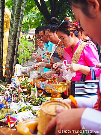 People making merit, Buddhist, Laos Editorial Stock Photo