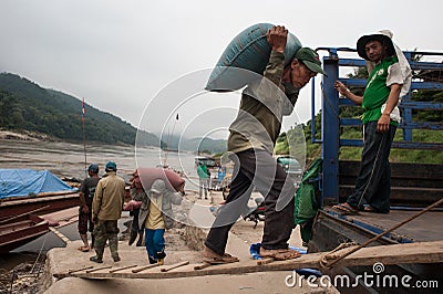 Laotian porters on the Mekong River Editorial Stock Photo