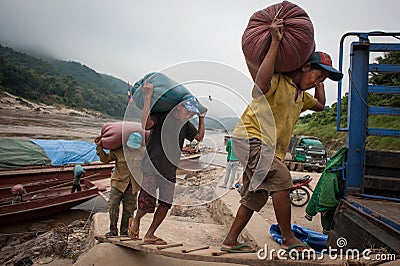 Laotian porters on the Mekong River Editorial Stock Photo