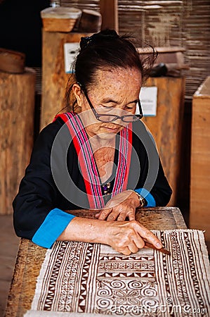 Laotian Senior woman do Batik fabric painting Editorial Stock Photo