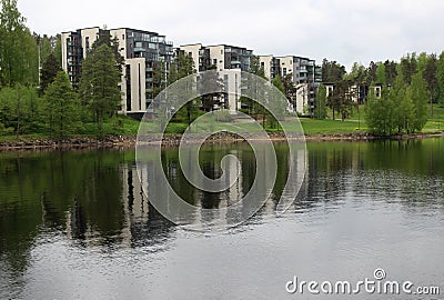 Lappeeranta - view of the lake with reflections, beautiful white houses among green trees, spring nature Stock Photo