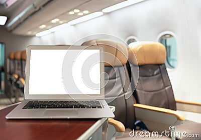 Laptop blank screen in luxury passenger flight cabin business economy class background for transport technology graphics design Stock Photo