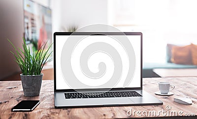 Laptop with blank screen mockup template on table in industrial old factory loft interior Stock Photo