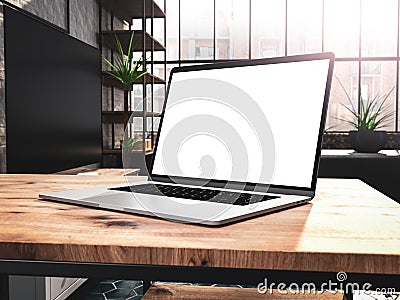 Laptop with blank screen mockup template on table in industrial old factory loft interior Stock Photo