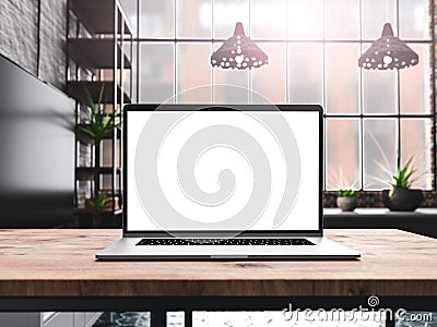 Laptop with blank screen mockup template on table in industrial old factory loft interior Stock Photo