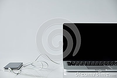 Laptop with blank screen and smartphone Stock Photo
