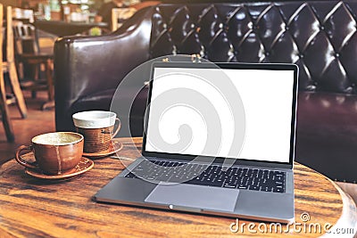 Laptop with blank white desktop screen and coffee cup on wooden table in cafe Editorial Stock Photo