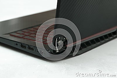 Laptop is broken with arm hinge on the screen,laptop cover,repair loop. cracked plastic laptop split case. computer Stock Photo