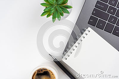 Laptop, coffee cup, plant, notebook on white background. Workspace concept. Stock Photo