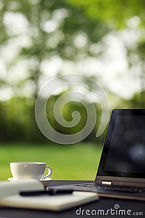 Laptop and coffee, outdoor office Stock Photo