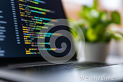Laptop with colorful programming code on screen Stock Photo
