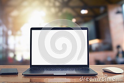 laptop computer blank white screen and mobile on table in cafe Stock Photo