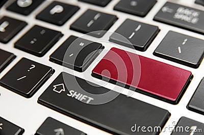 Laptop computer keyboard close up with red enter key Stock Photo