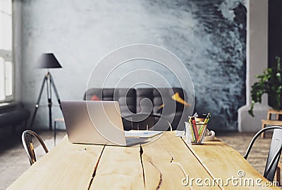 A laptop computer sitting on top of a wooden chair Stock Photo