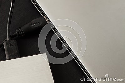 Laptop connected to an external hard drive Stock Photo