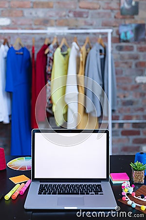 Laptop with copy space on screen lying on desk full of designers accessories Stock Photo