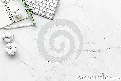Laptop, cotton branch, notebook on white background flat lay copy space. Minimal freelancer, blogger desk workspace. Editorial Stock Photo
