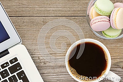 Laptop, cup of coffee and french macarons Stock Photo