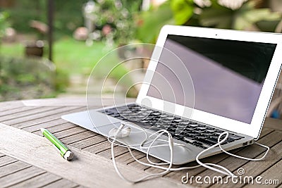 Laptop, garden background Stock Photo