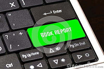 On the laptop keyboard the green button written BOOK REPORT Stock Photo