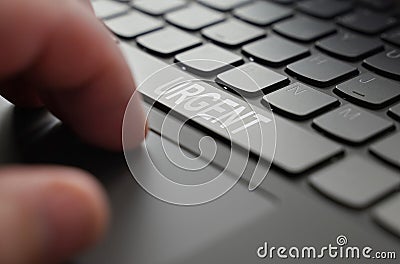 On the laptop keyboard of a person& x27;s hand, on the space bar there is an inscription - Urgent Stock Photo