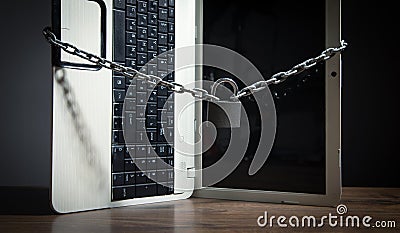 Laptop locked with chains and padlock Stock Photo