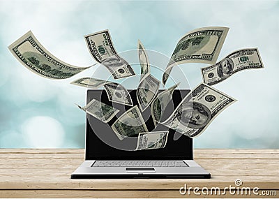 Laptop making money concept on background Stock Photo